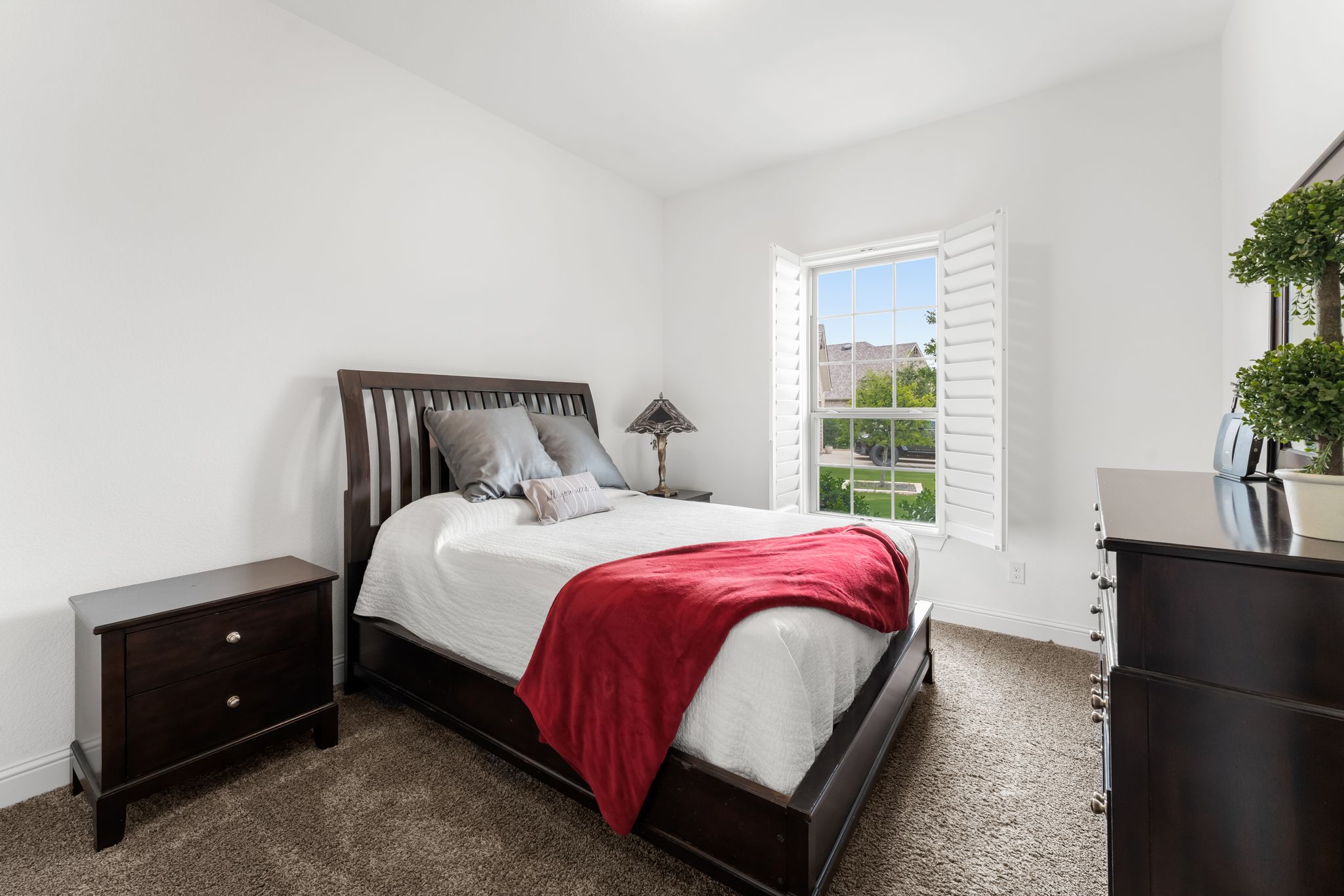 140 Waterloo Cove Georgetown, TX 78628 - Photo 28 of 40 Well-lit sleeping quarters feature soft carpeting and a window with a pleasant outdoor outlook.