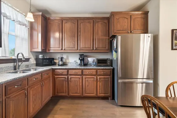 a kitchen with stainless steel appliances granite countertop a refrigerator a stove a sink and a granite counter tops