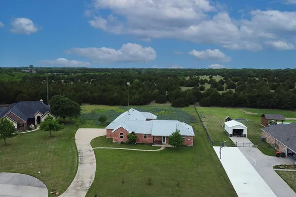 an aerial view of a house with pool a yard and lake view