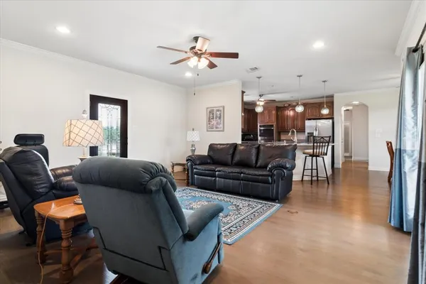 a living room with furniture and wooden floor