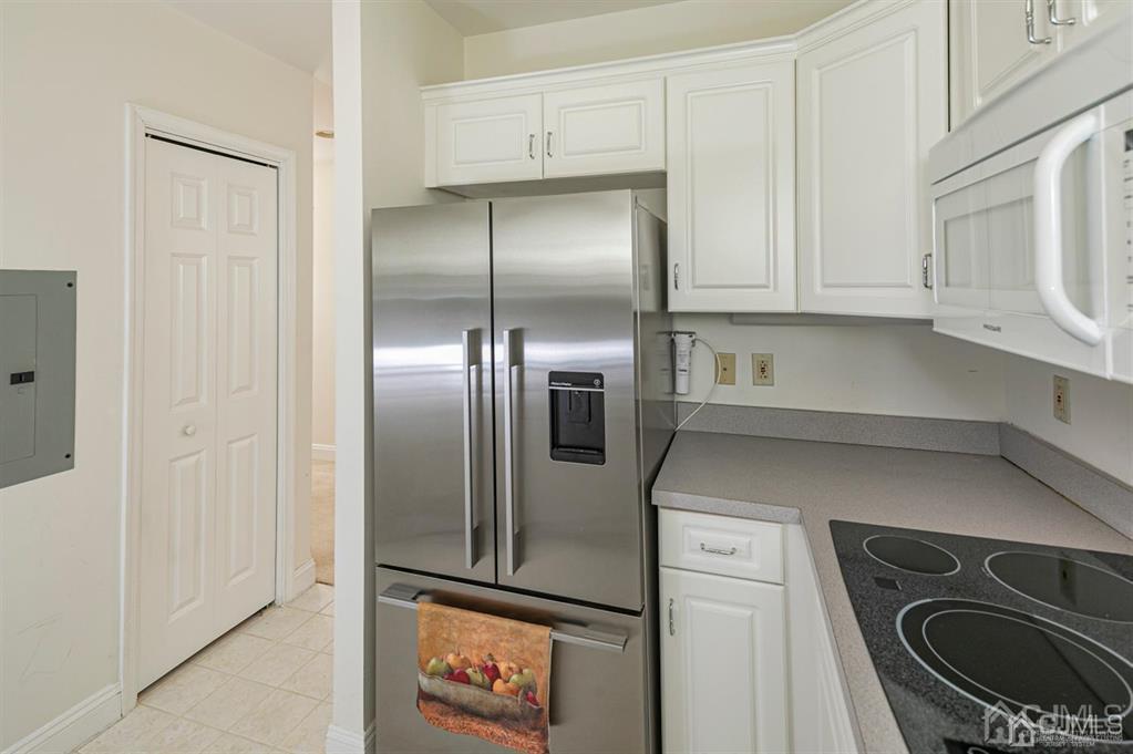 2423 Windrow Drive Plainsboro, NJ 08540 - Photo 14 of 36 a kitchen with a refrigerator and cabinets