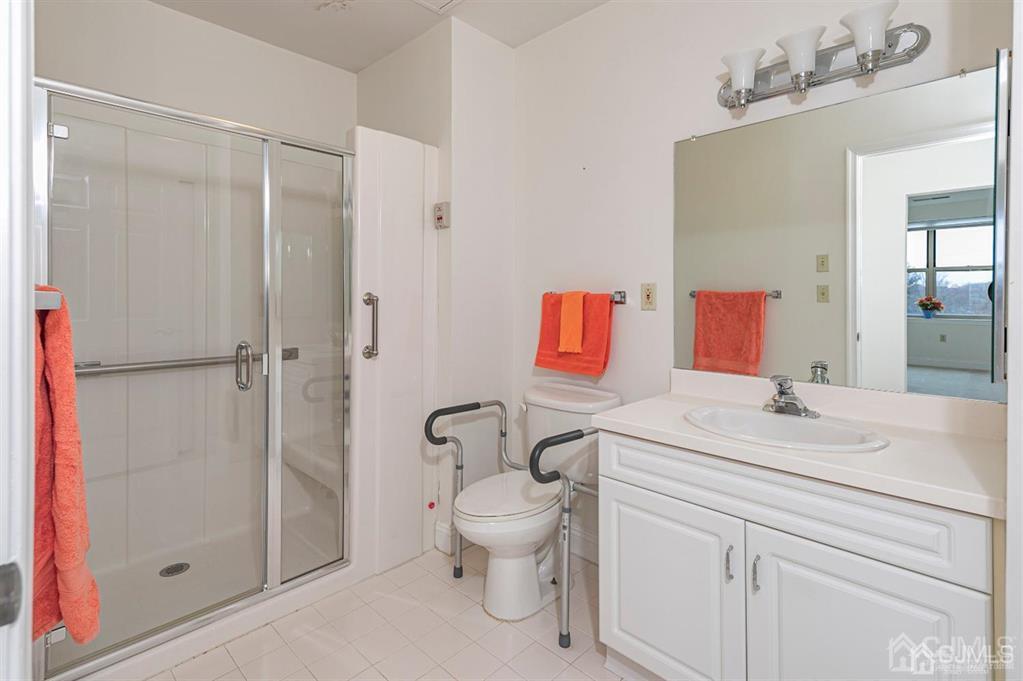 2423 Windrow Drive Plainsboro, NJ 08540 - Photo 22 of 36 a bathroom with a sink toilet vanity and shower