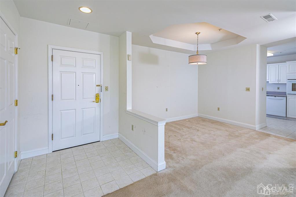 2423 Windrow Drive Plainsboro, NJ 08540 - Photo 5 of 36 an empty room with a mirror