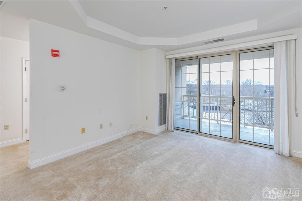 2423 Windrow Drive Plainsboro, NJ 08540 - Photo 7 of 36 a view of an empty room with glass door and balcony