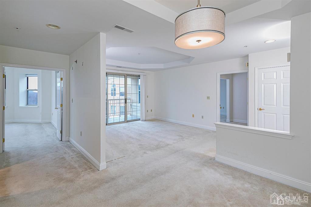 2423 Windrow Drive Plainsboro, NJ 08540 - Photo 9 of 36 an empty room with windows and mirror