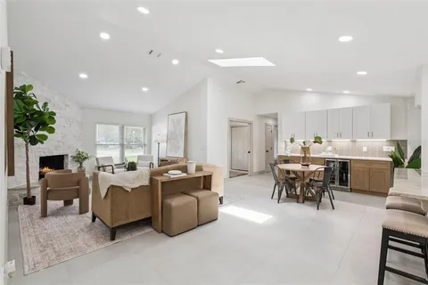 a spacious bathroom with a double vanity sink a mirror and a bathtub