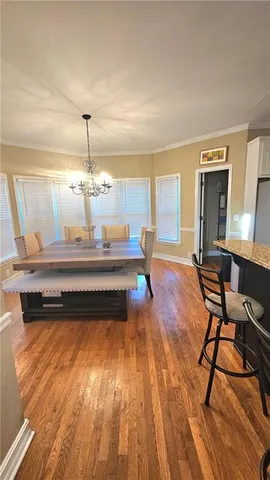 a room with wooden floor and breakfast area