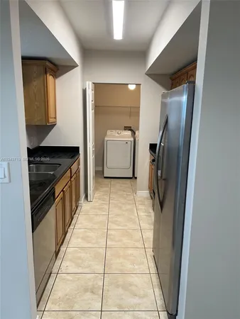 a kitchen with stainless steel appliances granite countertop a refrigerator and a stove