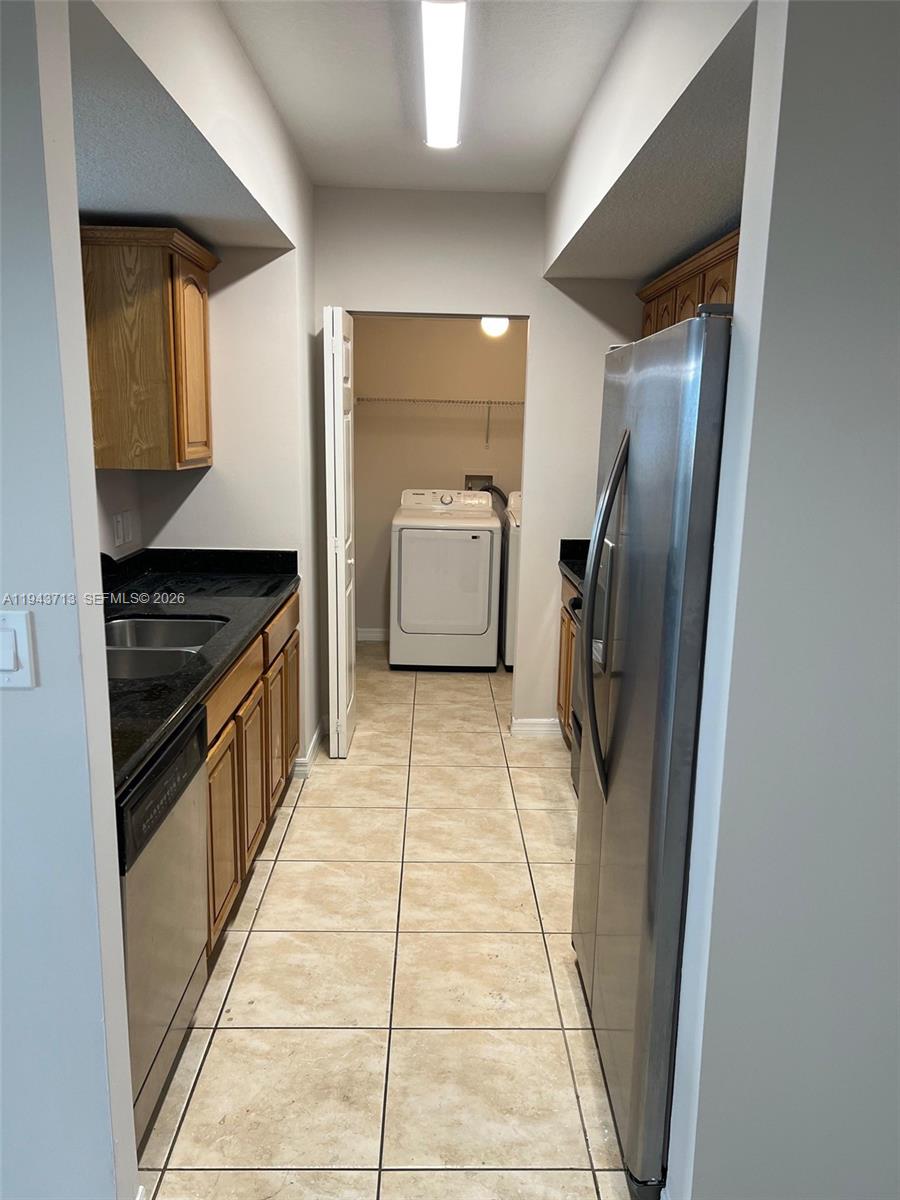 4242 Northwest 2nd Street, Unit 1108 Miami, FL 33126 - Photo 3 of 11 a kitchen with stainless steel appliances granite countertop a refrigerator and a stove