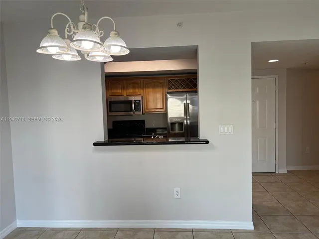 a view of a hallway with chandelier