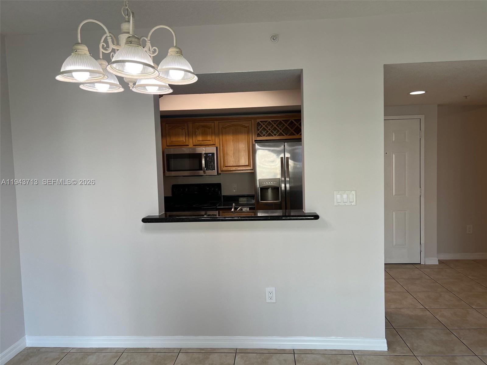 4242 Northwest 2nd Street, Unit 1108 Miami, FL 33126 - Photo 4 of 11 a view of a hallway with chandelier