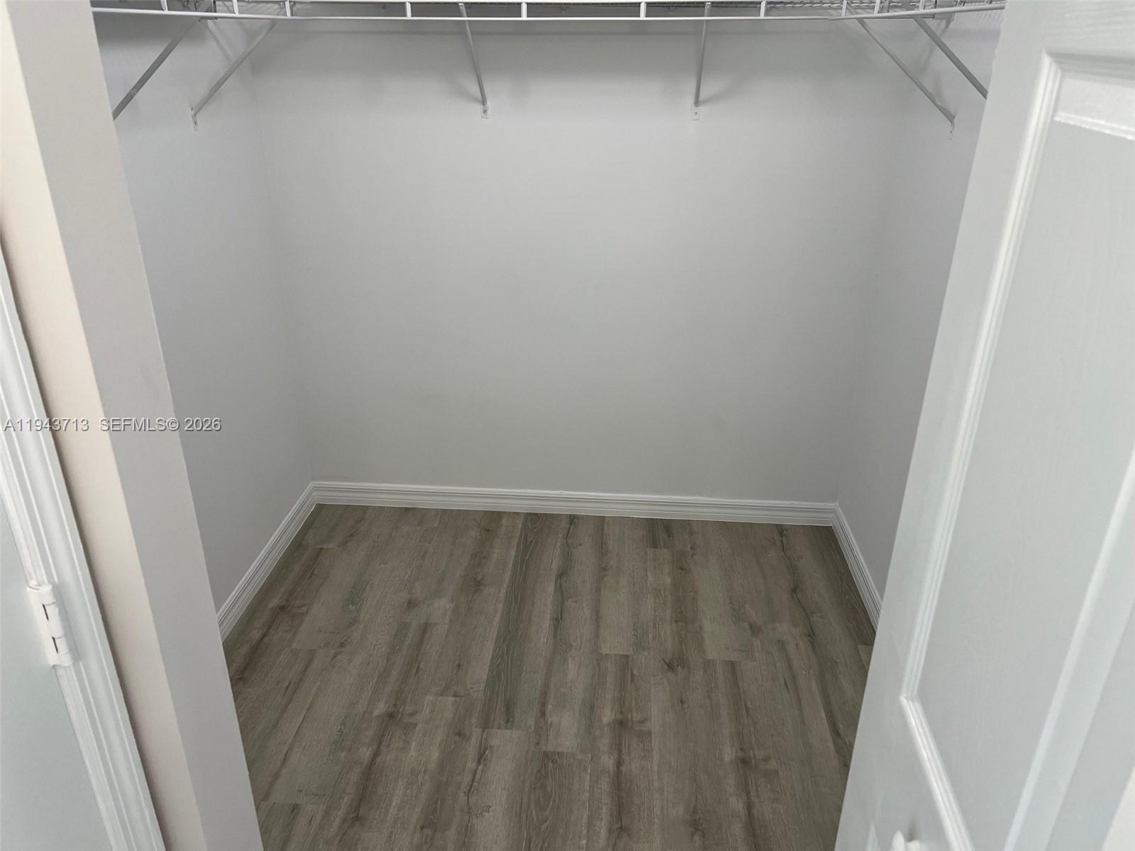 4242 Northwest 2nd Street, Unit 1108 Miami, FL 33126 - Photo 7 of 11 a view of walk in closet with wooden floor