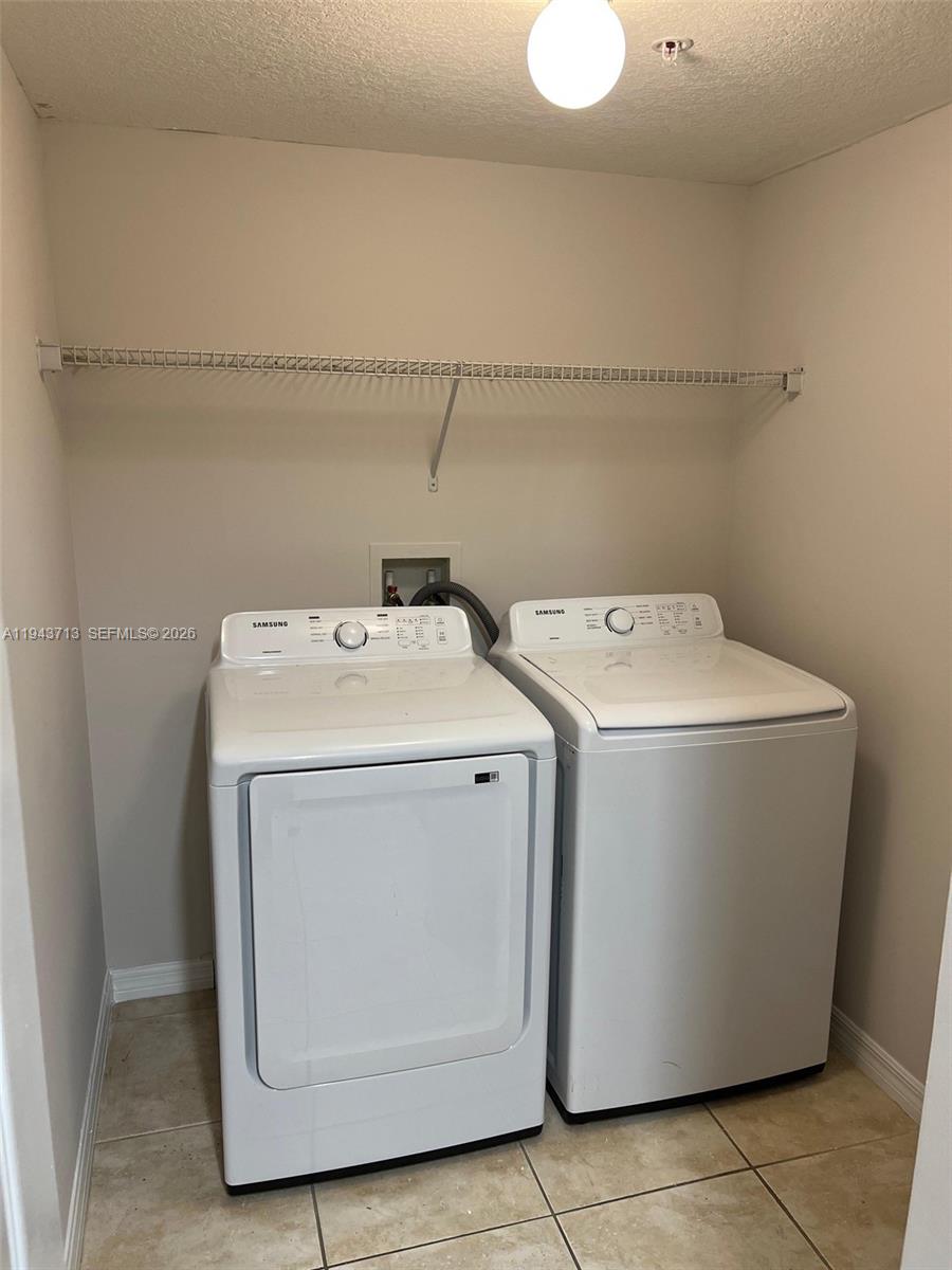4242 Northwest 2nd Street, Unit 1108 Miami, FL 33126 - Photo 10 of 11 a utility room with dryer and washer