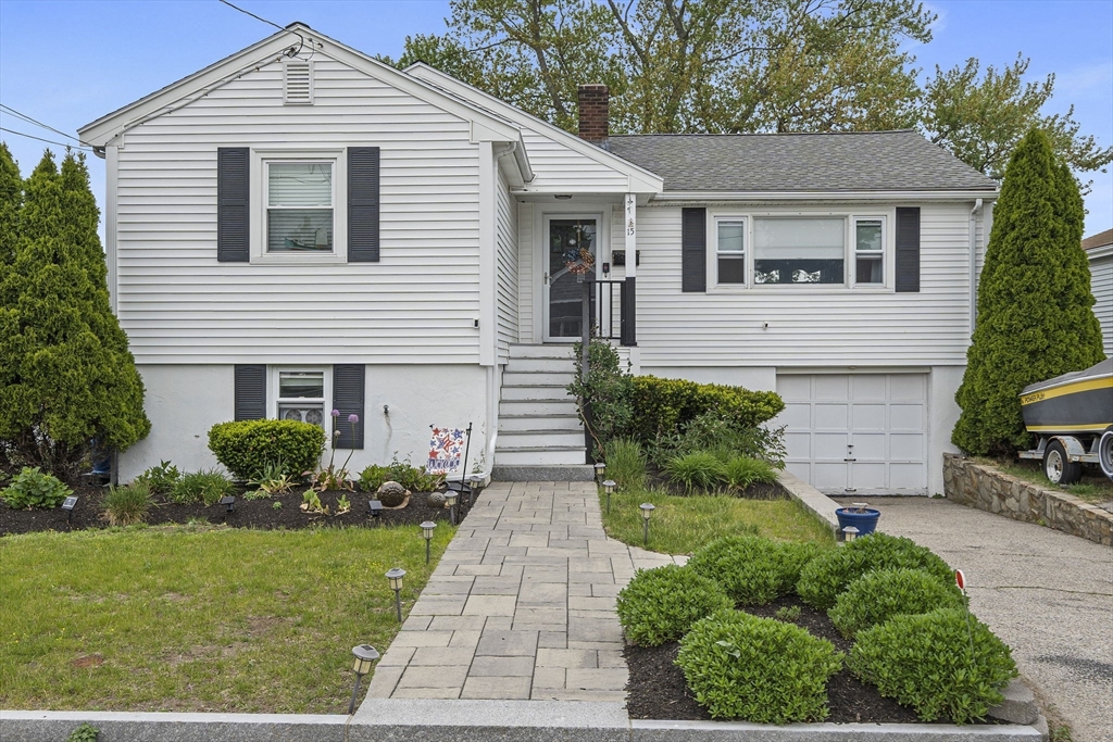a front view of a house with a garden