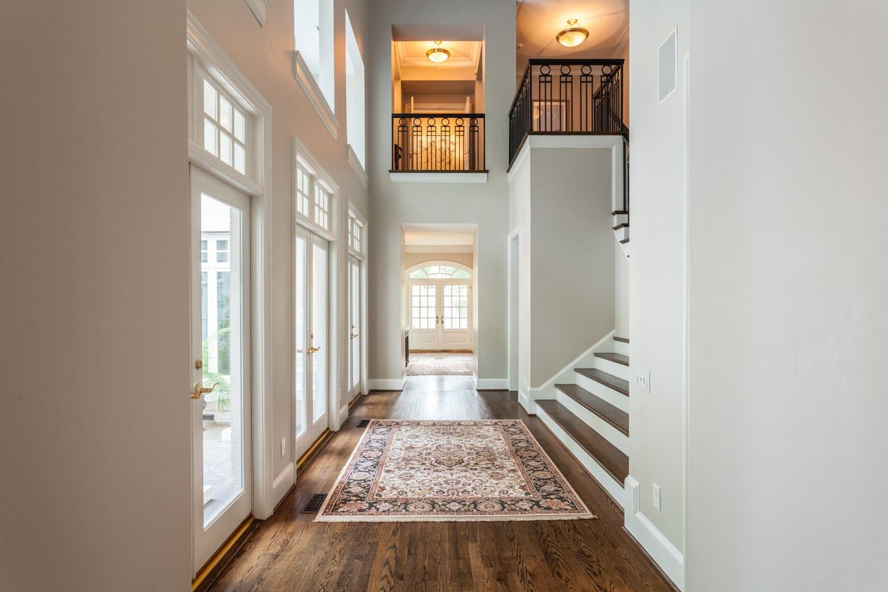 4921 Cremshaw Court Raleigh, NC 27614 - Photo 2 of 25 The central hallway is illuminated by 3 sets of double French doors with transoms. There is also a long accent shelf that runs the length of the hallway. The shelf is adorned with beautiful windows and accent lighting. The Central Hallway