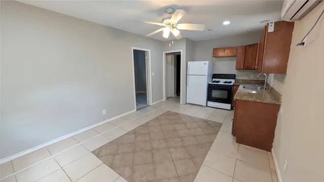a view of a kitchen with a sink and a refrigerator
