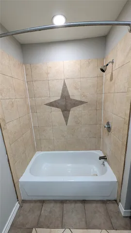 a bathroom with a bathtub and shower