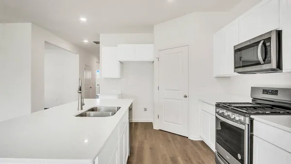 a kitchen that has a sink and a stove