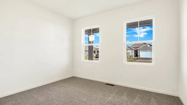 an empty room with windows and closet
