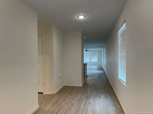 a kitchen with a refrigerator sink and cabinets