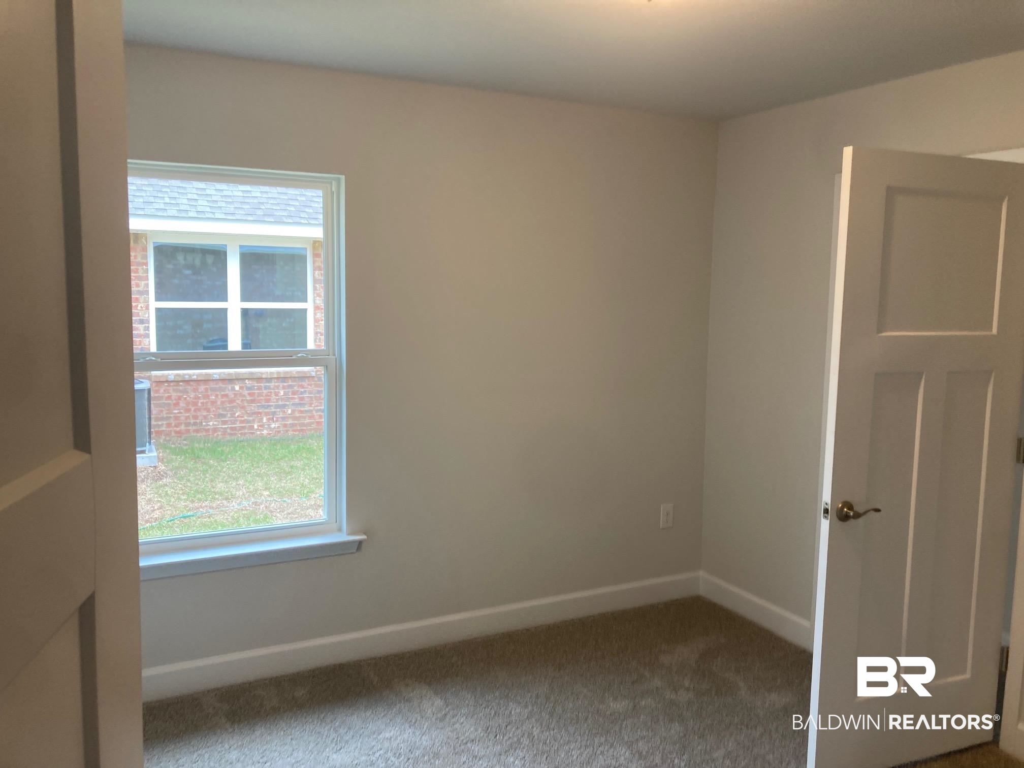 649 Revere Street Foley, AL 36535 - Photo 9 of 18 Carpeted empty room featuring baseboards