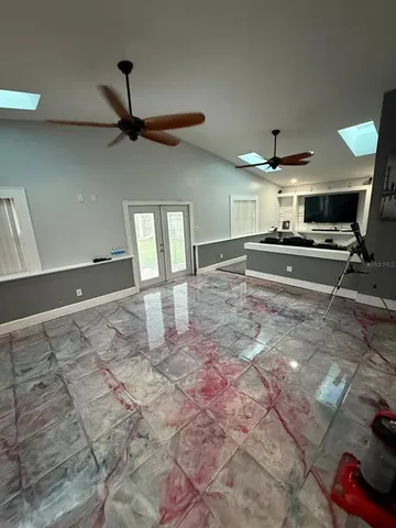 a open kitchen with kitchen island a stove a sink and a counter top space