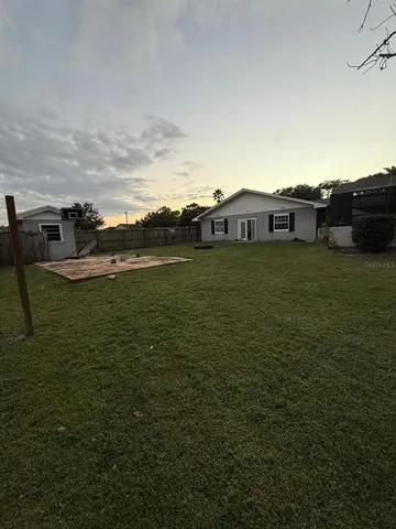 a backyard of a house with lots of green space and mountain view in back