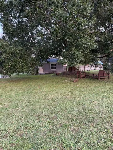a view of a swimming pool and lounge chairs