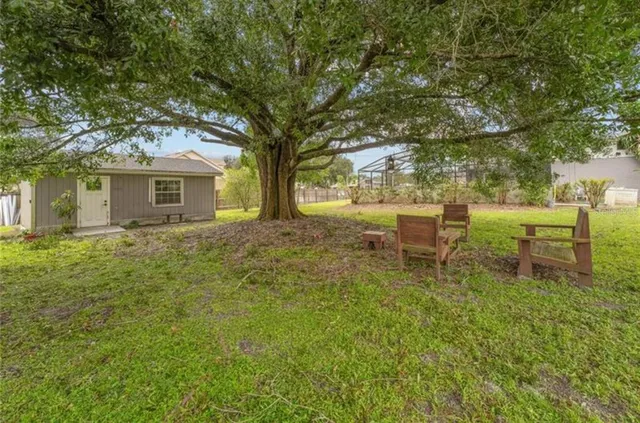a backyard of a house with table and chairs
