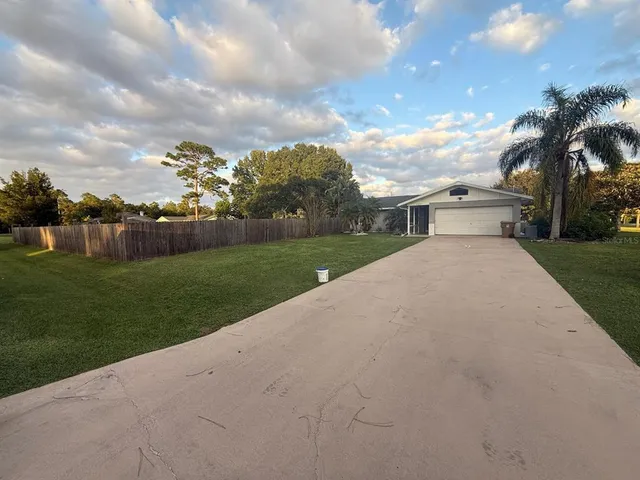 a view of a house with a yard and entertaining space