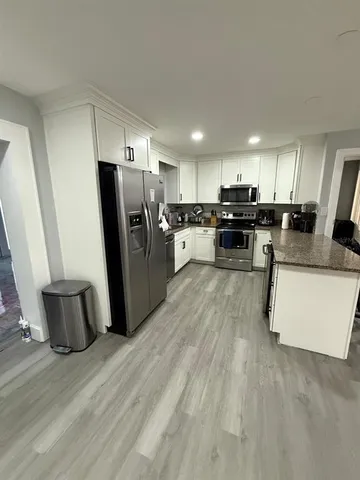 a kitchen with refrigerator and microwave