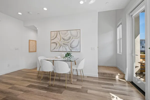 a dining room with wooden floor and breakfast area