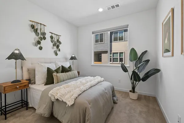 a bedroom with bed and a window