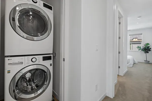 a view of a hallway with washer and dryer