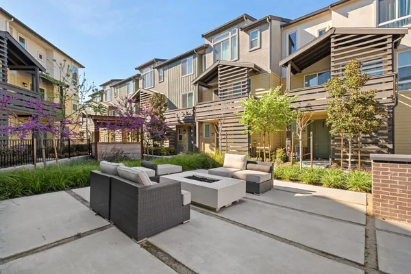 a view of a patio with couches and potted plants