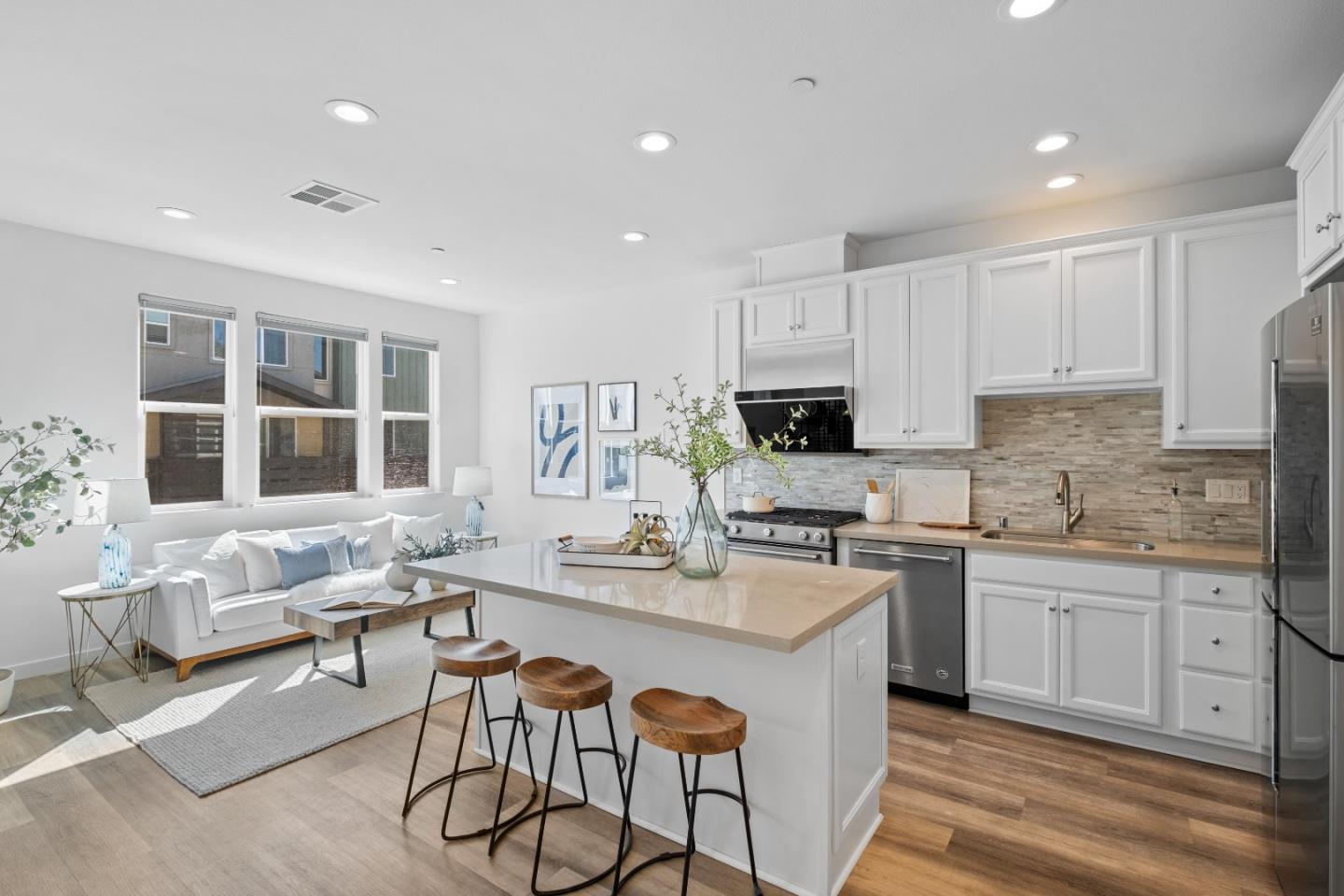 511 Sage Court Milpitas, CA 95035 - Photo 6 of 47 a kitchen with stainless steel appliances granite countertop a stove a sink dishwasher a microwave oven and a dining table with wooden cabinet