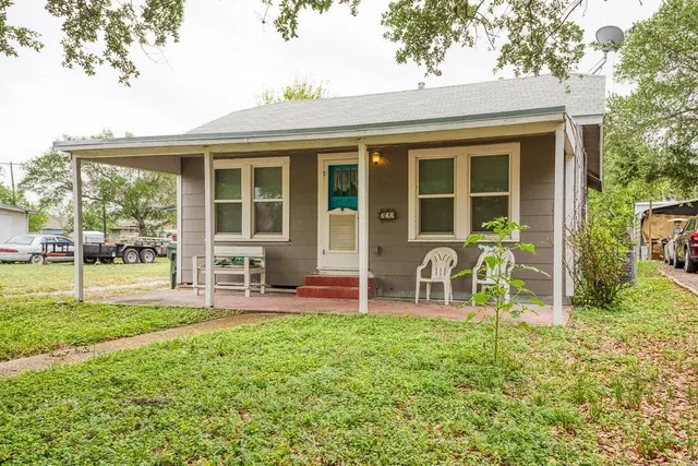 a house view with a sitting space and garden