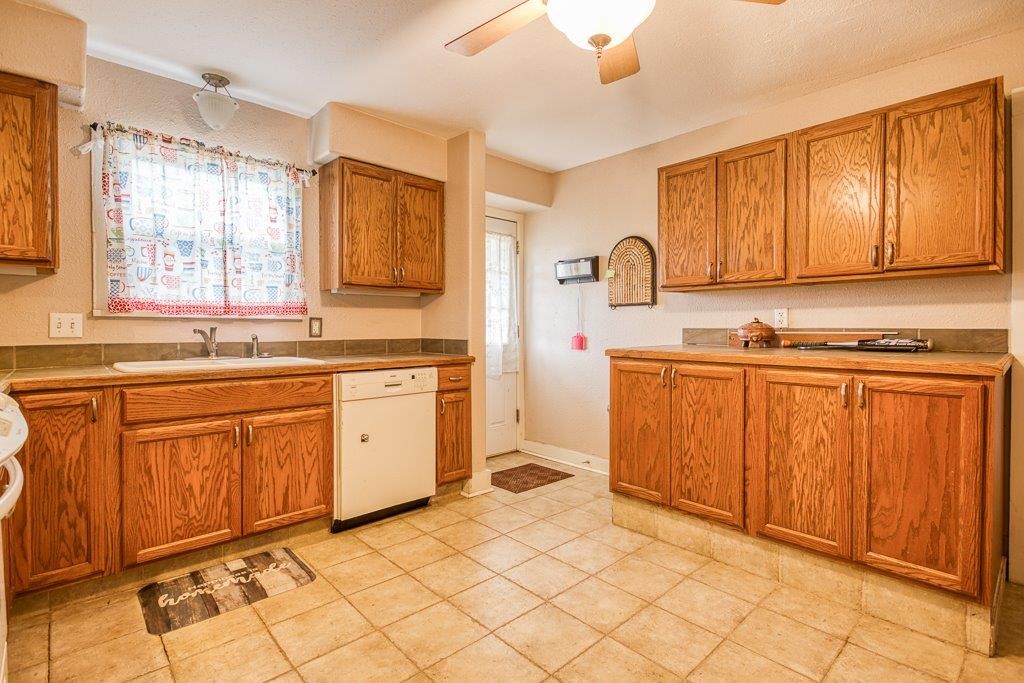 322 Fetick Avenue Taft, TX 78390 - Photo 19 of 34 a kitchen with a sink stove and cabinets