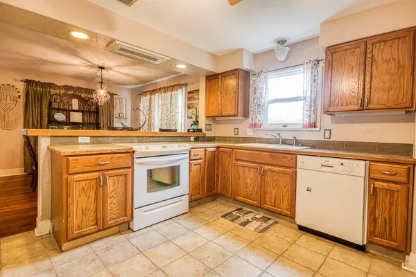 a kitchen with a stove sink and cabinets