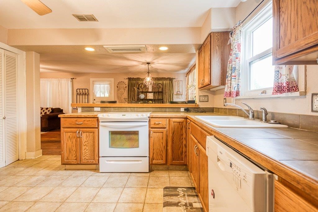 322 Fetick Avenue Taft, TX 78390 - Photo 22 of 34 a kitchen with stainless steel appliances granite countertop a sink stove and cabinets