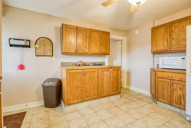 a bathroom with a granite countertop sink and a washing machine