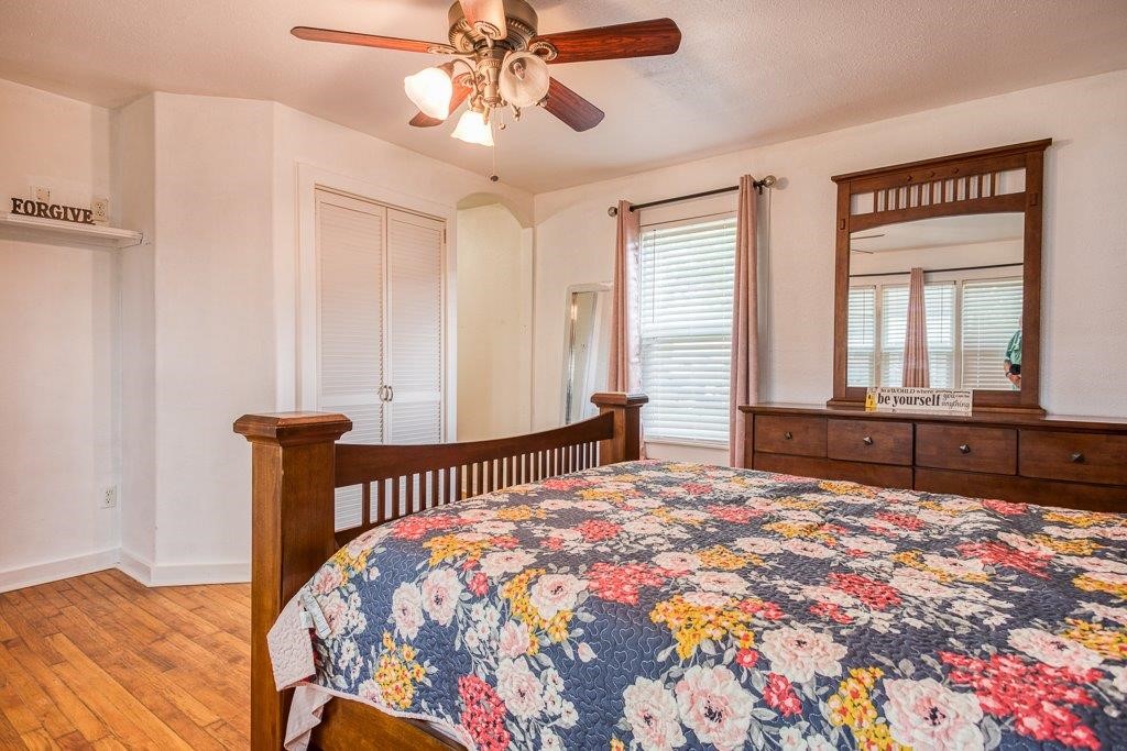 322 Fetick Avenue Taft, TX 78390 - Photo 27 of 34 a bedroom with a bed and a chandelier