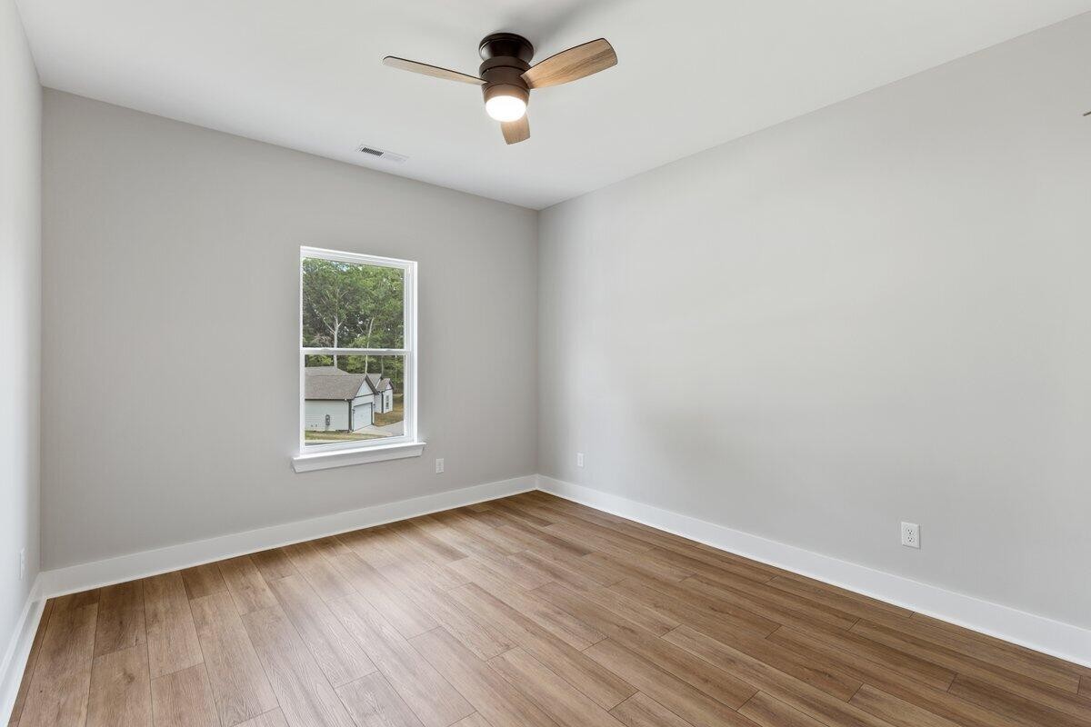 129 County Road 155 Riceville, TN 37370 - Photo 14 of 31 an empty room with wooden floor and windows