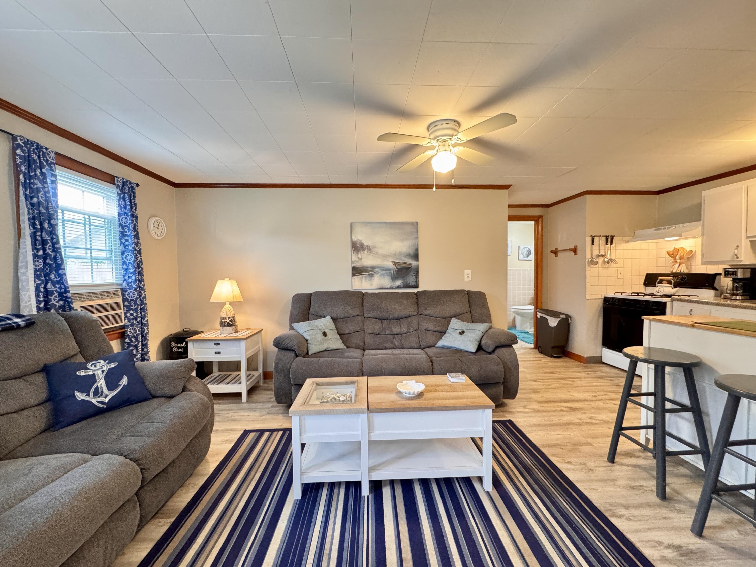 56-58 Uncle Rolf Road Dennis Port, MA 02639 - Photo 11 of 44 a living room with furniture and a fireplace