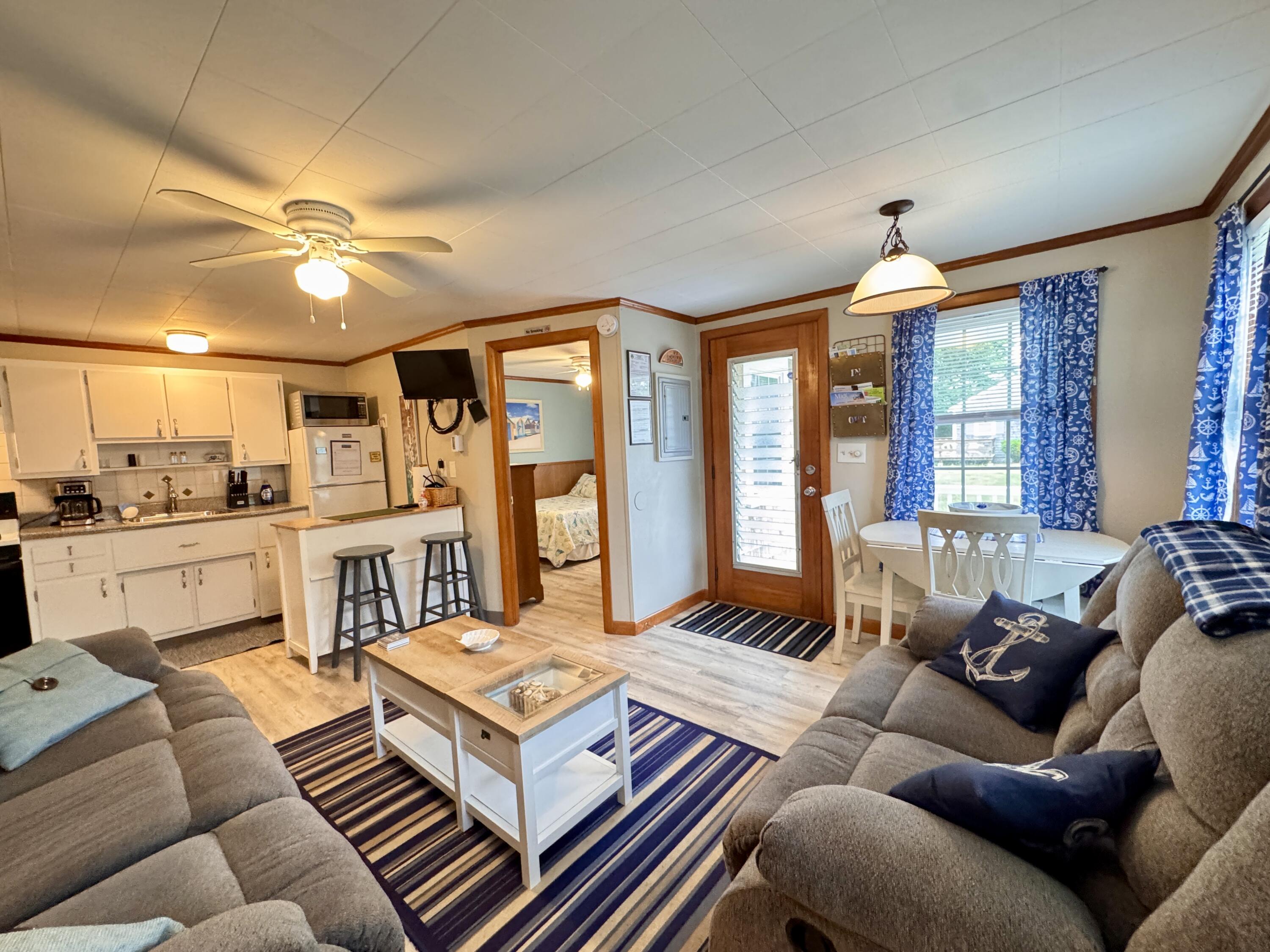 56-58 Uncle Rolf Road Dennis Port, MA 02639 - Photo 12 of 44 a living room with furniture fireplace and a large window