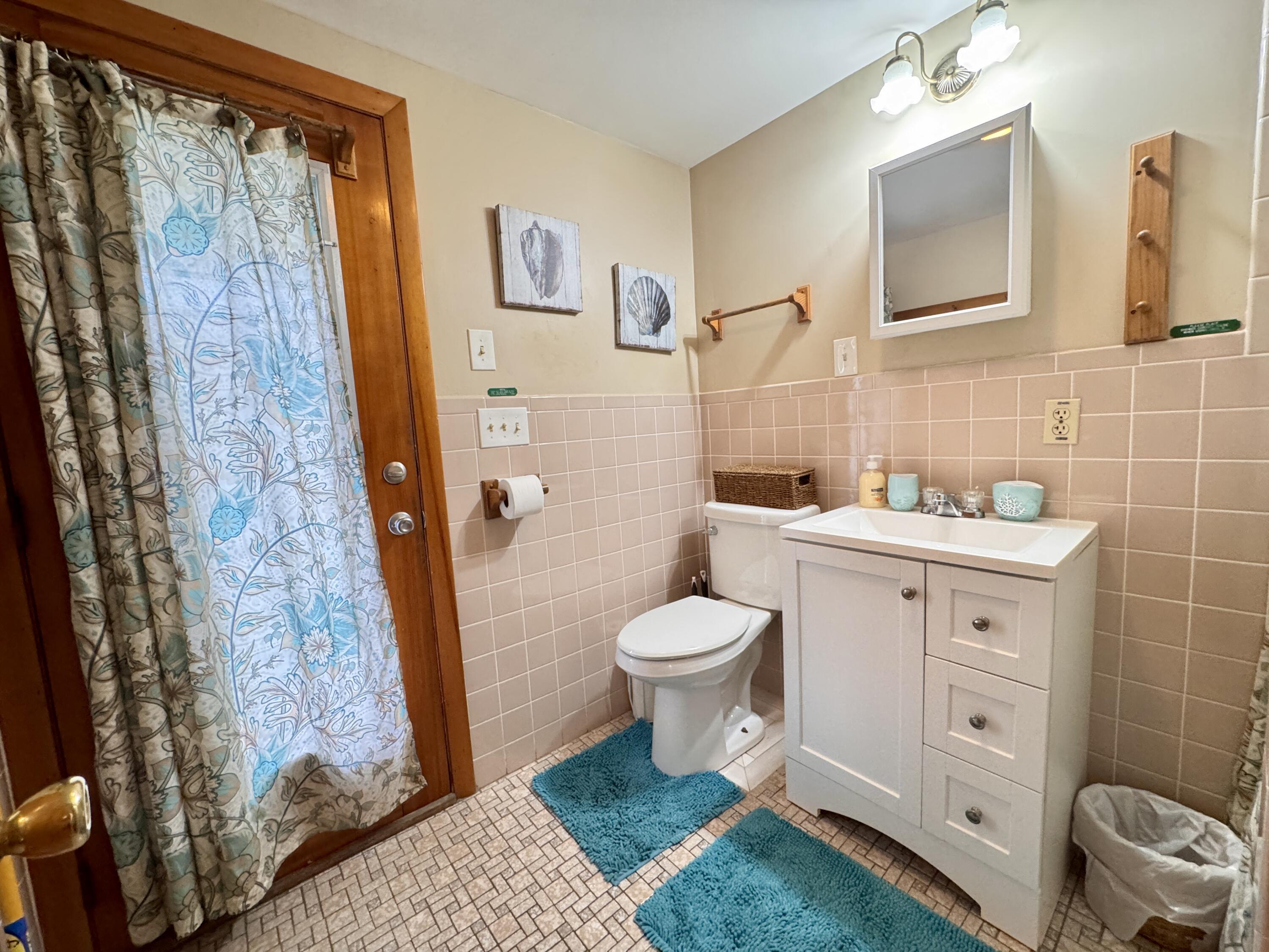 56-58 Uncle Rolf Road Dennis Port, MA 02639 - Photo 18 of 44 a bathroom with a toilet sink and shower