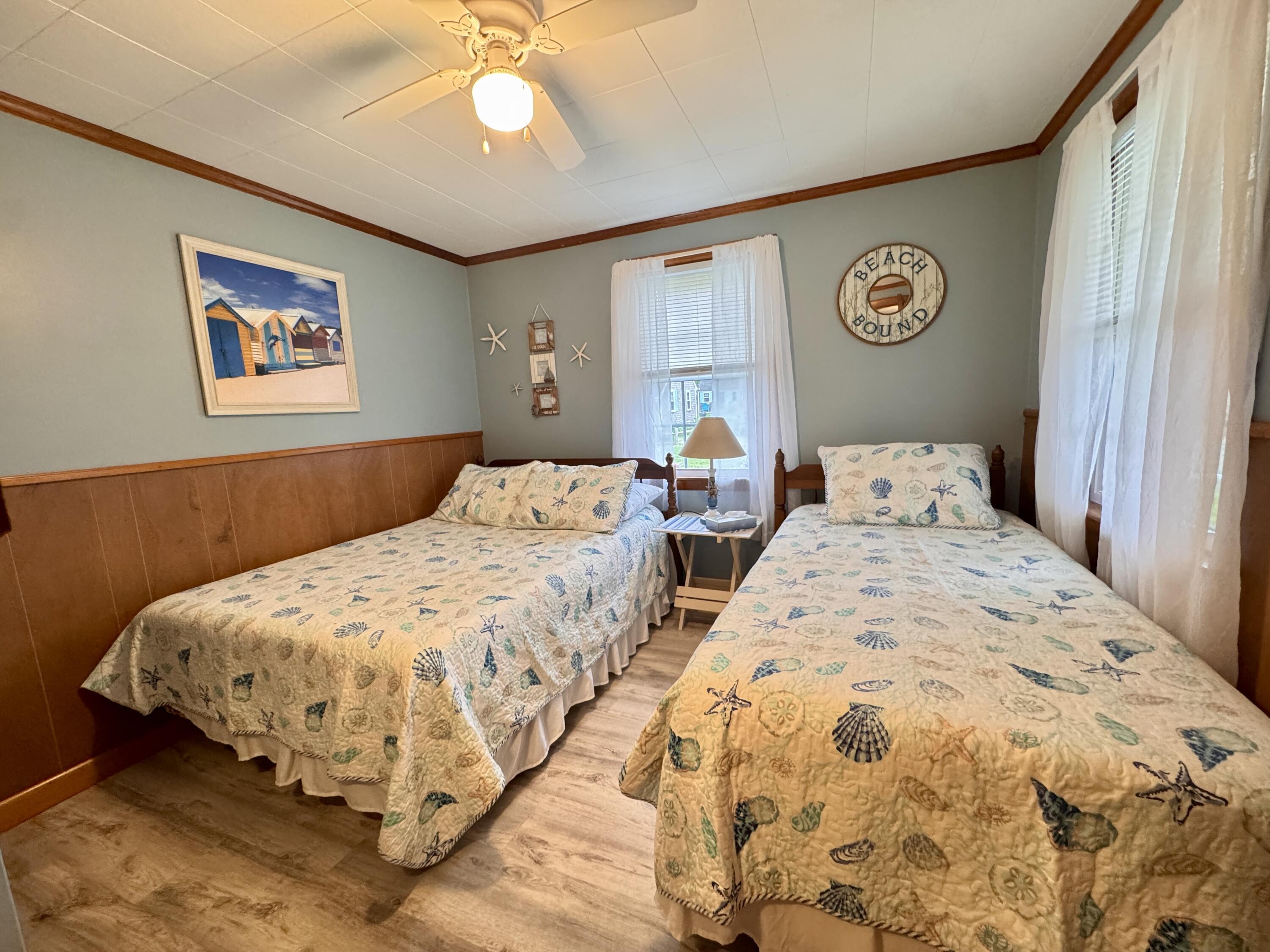 56-58 Uncle Rolf Road Dennis Port, MA 02639 - Photo 19 of 44 a bedroom with bed and wall painting