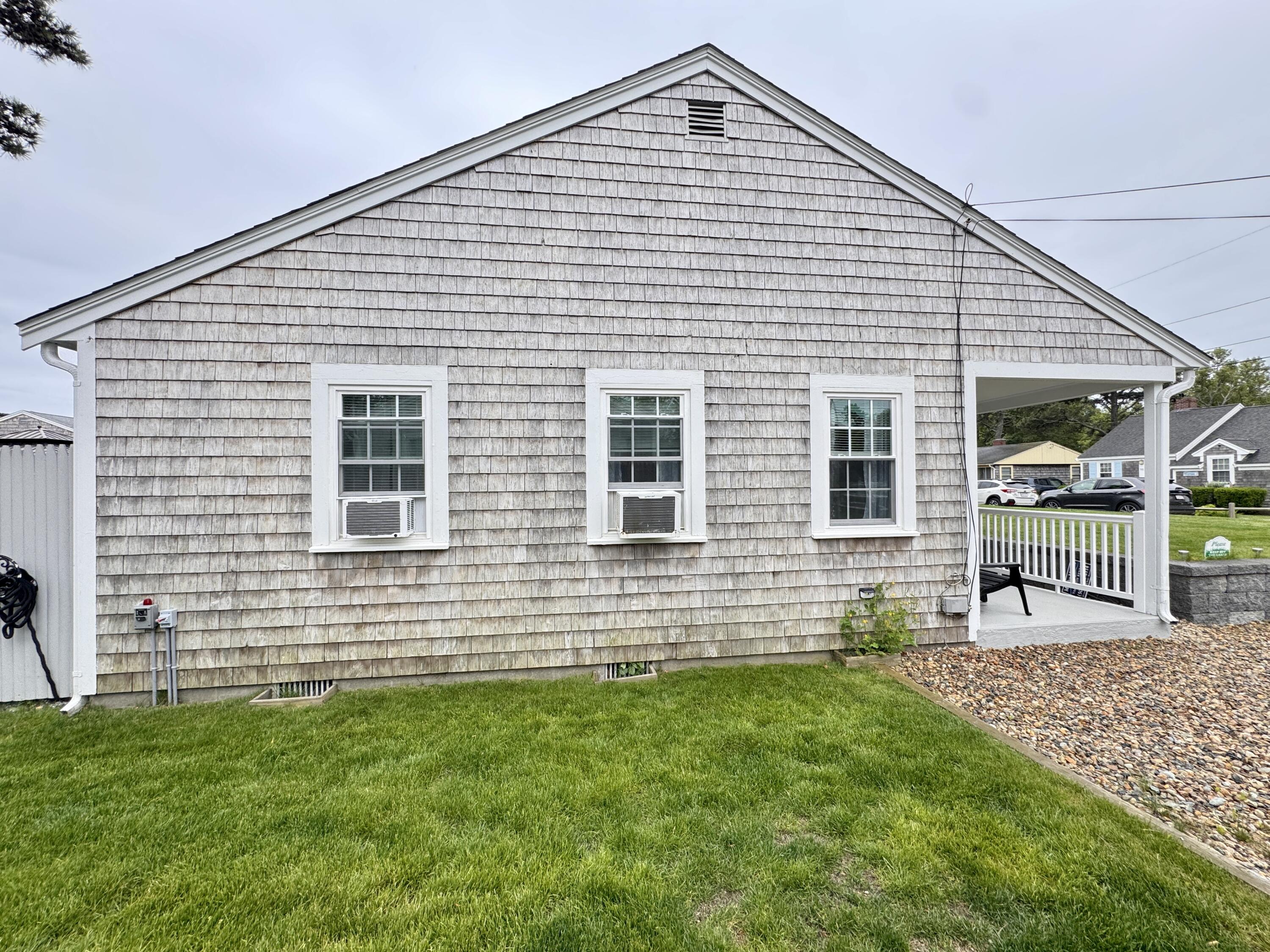 56-58 Uncle Rolf Road Dennis Port, MA 02639 - Photo 2 of 44 a front view of a house with a yard