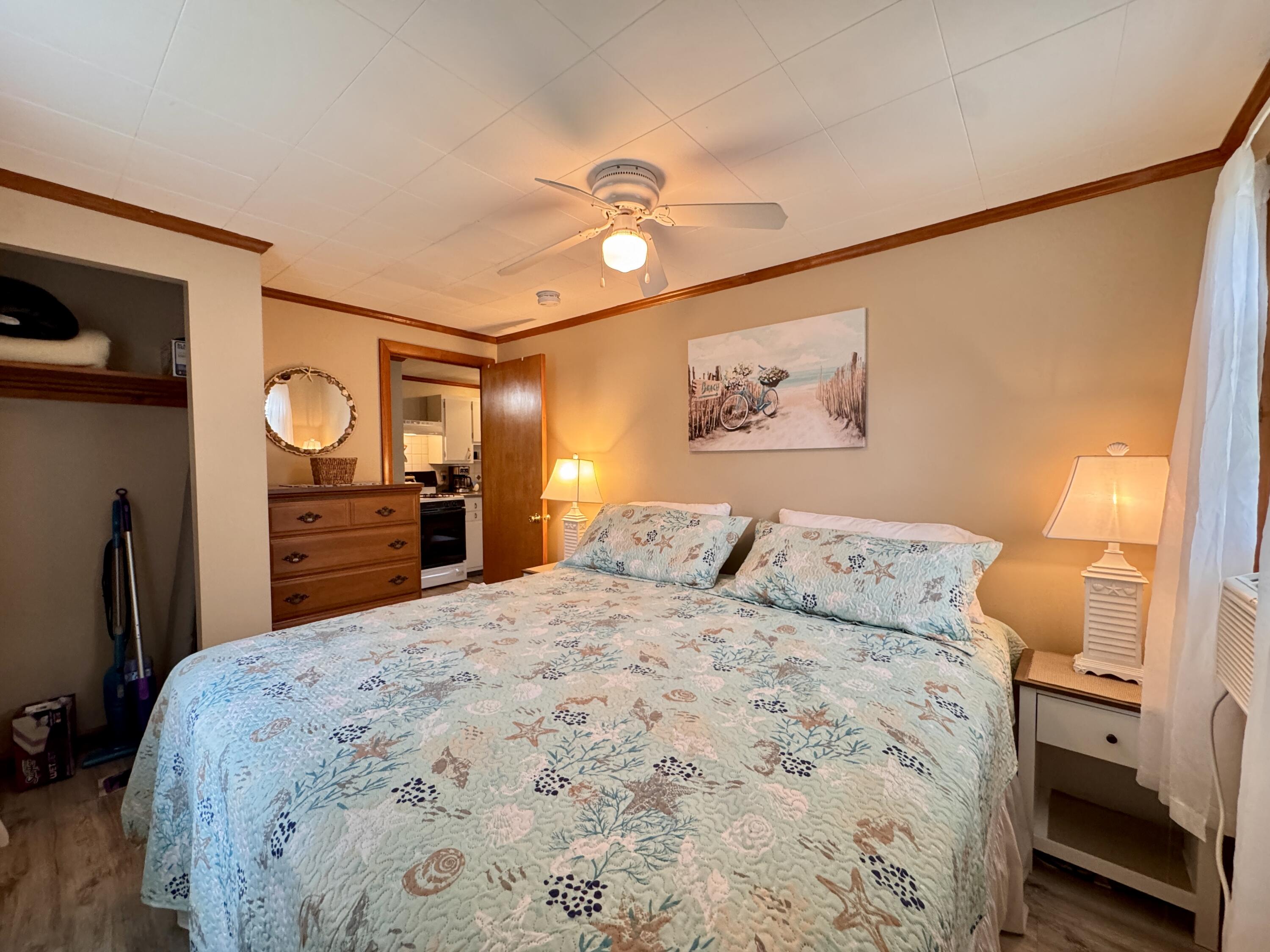 56-58 Uncle Rolf Road Dennis Port, MA 02639 - Photo 21 of 44 a bedroom with a bed and a lamp on dresser