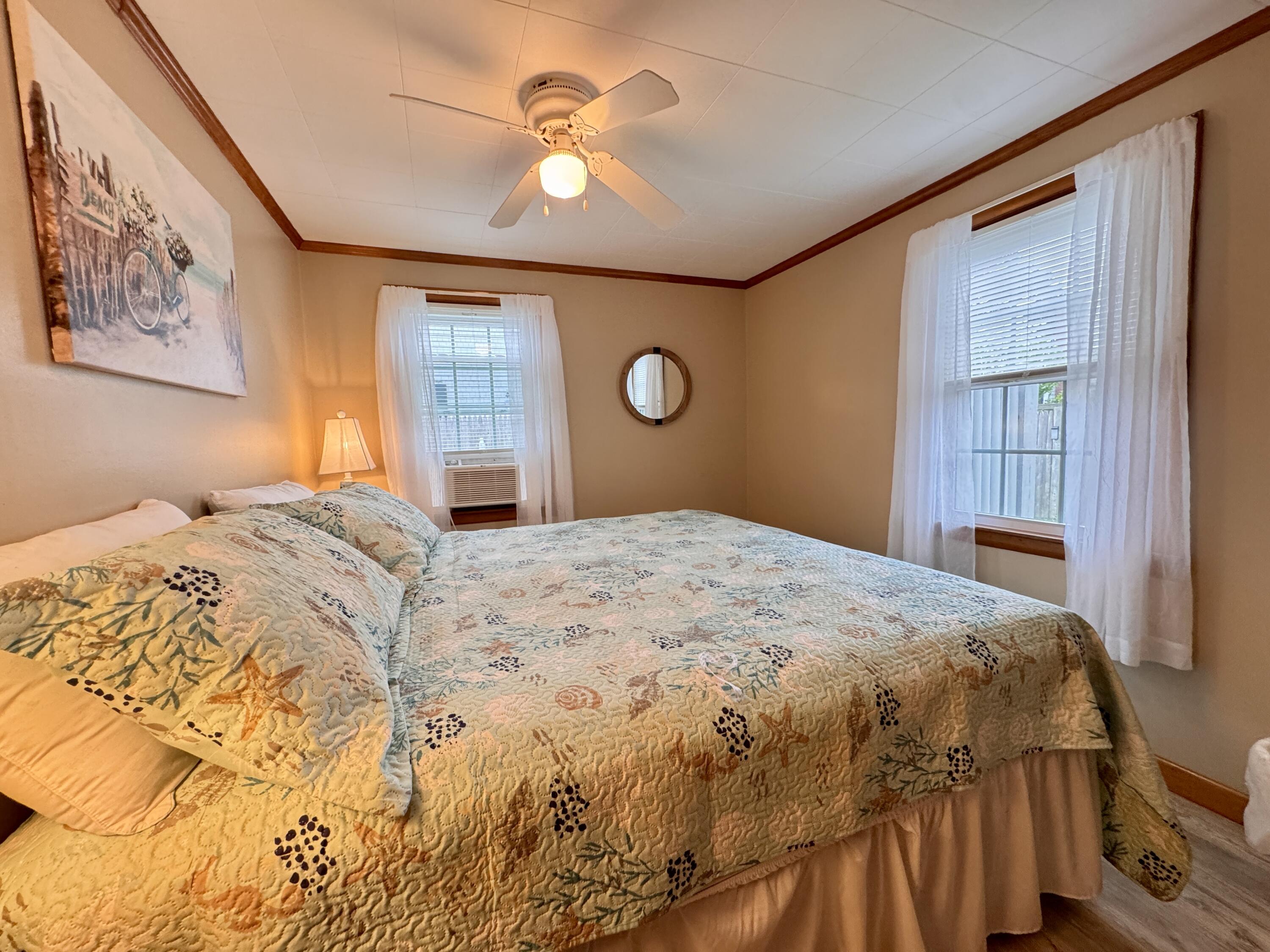 56-58 Uncle Rolf Road Dennis Port, MA 02639 - Photo 22 of 44 a bedroom with a large bed and a chandelier